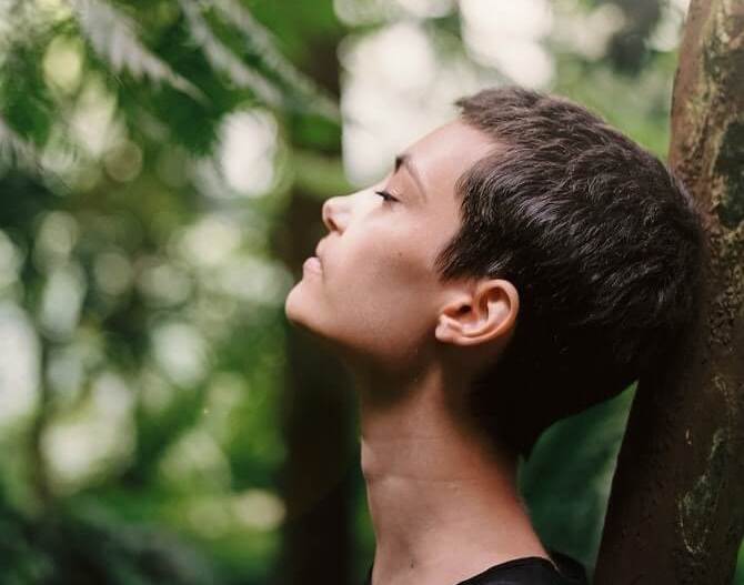 Lady reducing stress using mindfulness meditation and breathing